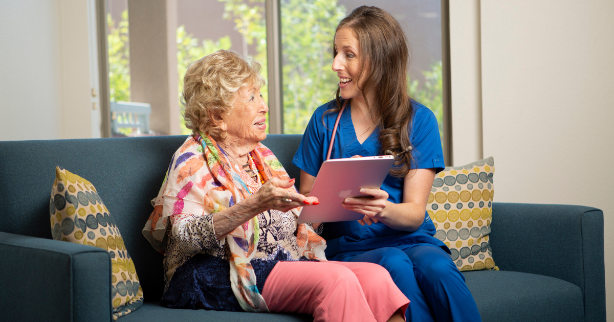 Senior Woman and Doctor looking at an iPad.