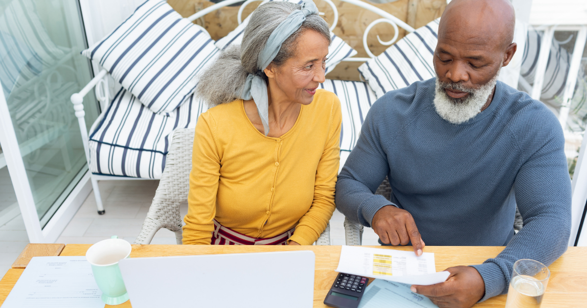 Senior couple comparing their senior living options in front of a computer.